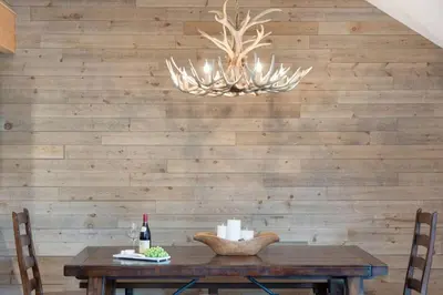 a dining room with a table and a chandelier at Large Village loft with Private Hot Tub and Private Sauna in Whistler