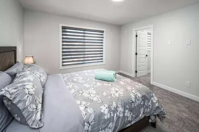 a bedroom with a bed and a window at Near Downtown, Large 3BR! FREE Banff Pass, Netflix, Parking! in Calgary