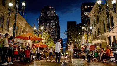 a group of people walking down a city street at night at Near Downtown, Large 3BR! FREE Banff Pass, Netflix, Parking! in Calgary