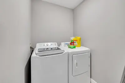 a white kitchen with a stove and a refrigerator at Luxury family vacation rental in Laurel Edmonton in Edmonton