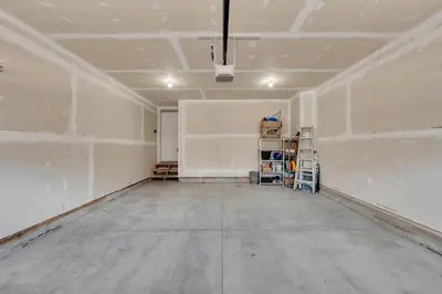 an empty room with white walls and a concrete floor at Luxury family vacation rental in Laurel Edmonton in Edmonton