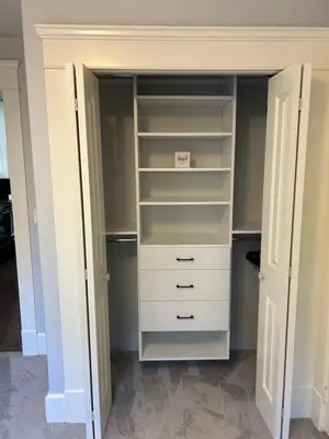 a walk in closet with white drawers and shelves at Garden Suite in Colwood in Victoria