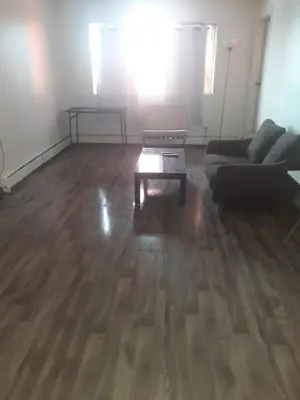 a living room with a couch and a coffee table at Victoria Trail Apartments in Edmonton