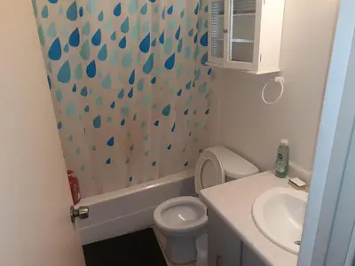 a bathroom with a sink and a toilet and a shower at Victoria Trail Apartments in Edmonton