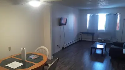 a living room with a table and a couch at Victoria Trail Apartments in Edmonton