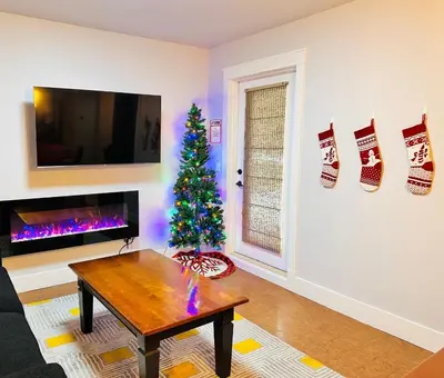 a living room with a christmas tree and a coffee table at C111 Canmore World Class Solara Resort - Hot tub, Pool, Gym, AirCon, Free Parking & Netflix in Canmore