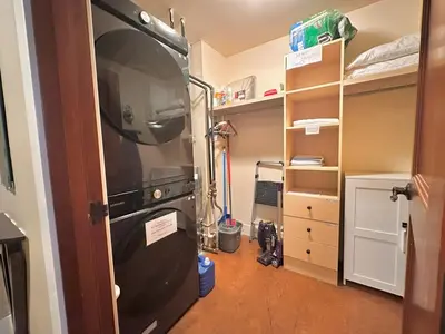 a kitchen with a refrigerator in a room at C111 Canmore World Class Solara Resort - Hot tub, Pool, Gym, AirCon, Free Parking & Netflix in Canmore
