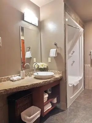 a bathroom with a sink and a shower at C111 Canmore World Class Solara Resort - Hot tub, Pool, Gym, AirCon, Free Parking & Netflix in Canmore