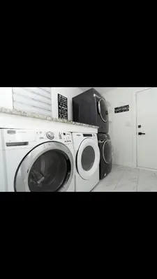 a washing machine with a microwave on top of it at Modern and luxury 3500 sq feet house jetted tub over 10000 sq feet lot in Edmonton