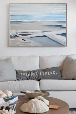 a living room with a couch with a painting on the wall at Saratoga Beachfront Villa in Oyster Bay