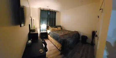 a small bedroom with a bed and a window at Charming Oasis Tranquil Suite 8 min Airport, AC in Calgary