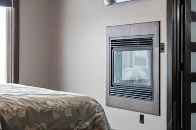 a bedroom with a window in the corner of a room at Luxurious Modern 11-Bed Home Private 136 Acres in Spruce Grove