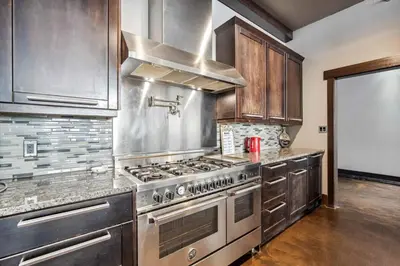 a kitchen with a stainless steel stove top oven at Luxurious Modern 11-Bed Home Private 136 Acres in Spruce Grove