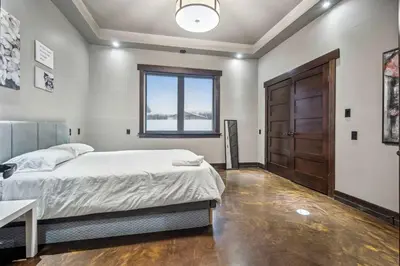 a bedroom with a bed and a window and a door at Luxurious Modern 11-Bed Home Private 136 Acres in Spruce Grove