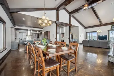 a dining room with a wooden table and chairs at Luxurious Modern 11-Bed Home Private 136 Acres in Spruce Grove