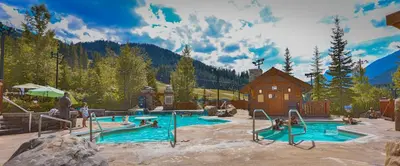 a pool in a resort with people playing in it at Riverbend Townhomes by StayIn in Panorama