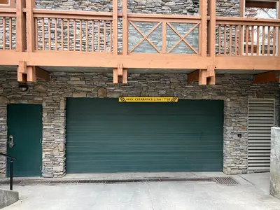 a garage with a green garage door on a building at Riverbend Townhomes by StayIn in Panorama