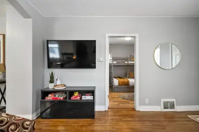 a living room with a flat screen tv on a wall at Sylvan Lake Nook Family-Friendly and Close to Beach in Sylvan Lake