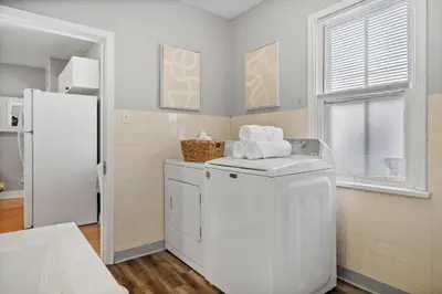 a white laundry room with a washer and dryer at Sylvan Lake Nook Family-Friendly and Close to Beach in Sylvan Lake
