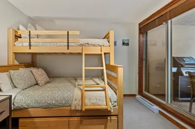 a bedroom with bunk beds in a tiny house at 2BR in Gleneagle, Heated Flooring, Wood Burning Fireplace, Shuttle to Gondola in Whistler