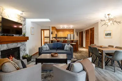 a living room with a couch and a fireplace at 2BR in Gleneagle, Heated Flooring, Wood Burning Fireplace, Shuttle to Gondola in Whistler