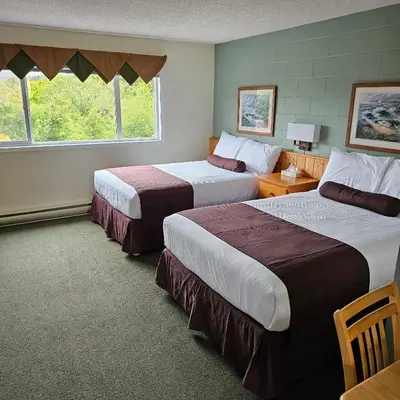 a hotel room with two beds and a window at Pacific Rim Motel in Ucluelet