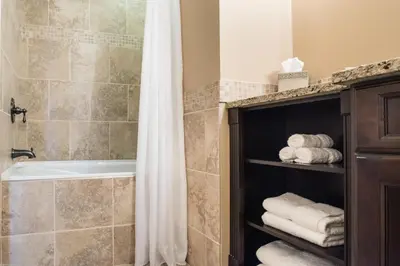 a bathroom with a shower curtain and a bath tub at The Castle at Swan Lake in Vernon