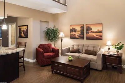 a living room with a couch and a chair at The Castle at Swan Lake in Vernon