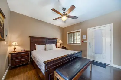 a bedroom with a bed and a ceiling fan at The Castle at Swan Lake in Vernon