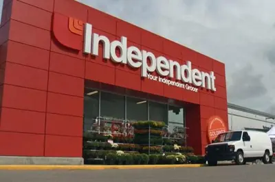 a red store front with a white car parked in front at Home Away Inn in Drayton Valley