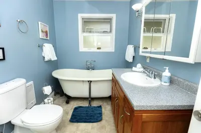 a bathroom with a tub and a toilet and a sink at Salal Forest - 2 bedroom cabin in the forest in Tofino