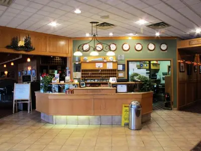 a restaurant with a counter in the middle of a store at Tamarack Inn in Rocky Mountain House