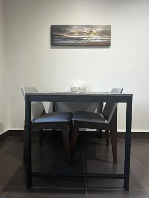 a table with two chairs and a picture on the wall at Luxury Vancouver Suite Near YVR and Downtown in Vancouver