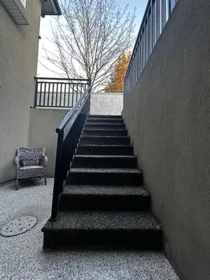 a stairway leading up to a building with a bench at Luxury Vancouver Suite Near YVR and Downtown in Vancouver
