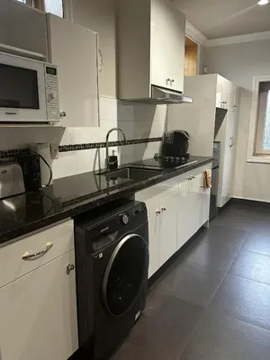 a kitchen with a washer and a dishwasher in it at Luxury Vancouver Suite Near YVR and Downtown in Vancouver