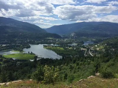 a view of a valley with a river and mountains at Canadas Best Value Inn & Suites-Castlegar in Castlegar