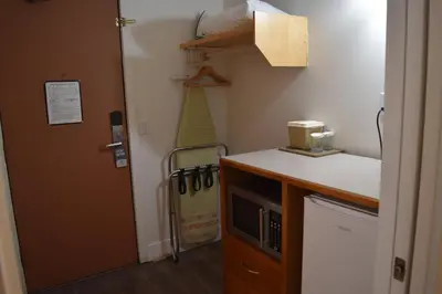 a room with a kitchen with a sink and a microwave at Canadas Best Value Inn & Suites-Castlegar in Castlegar