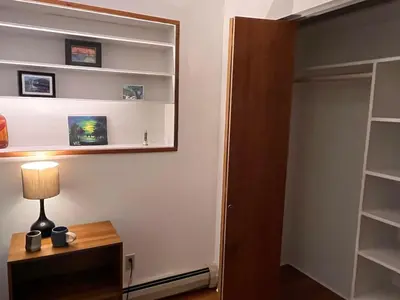 a room with a lamp on a table and a closet at Peter's Place - Spacious 2Bed & Bath Suite in Surrey