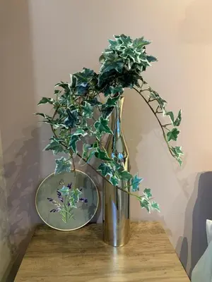 a vase with a plant in it on a table at The Scandinavian House by Maple Dream Homestay- near Sky train in Vancouver