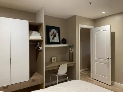 a bedroom with a bed and a desk and a chair at The Scandinavian House by Maple Dream Homestay- near Sky train in Vancouver