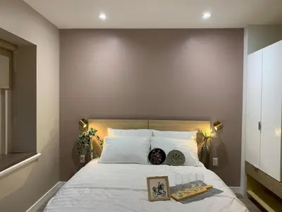a bedroom with a large white bed with a tray on it at The Scandinavian House by Maple Dream Homestay- near Sky train in Vancouver