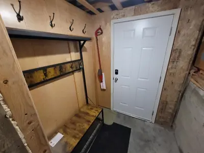 a small room with a door and a room with a wall at The Suite Treat in Whitehorse