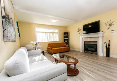 a living room with a couch and a fireplace at 2 BR Spacious Ground Level Suite in Victoria