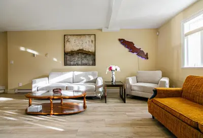a living room with a couch and a coffee table at 2 BR Spacious Ground Level Suite in Victoria