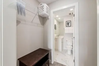 a white bathroom with a toilet and a sink at Pet Friendly, Free Parking, Close to Downtown in Calgary