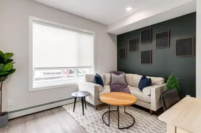 a living room with a couch and a window at Pet Friendly, Free Parking, Close to Downtown in Calgary