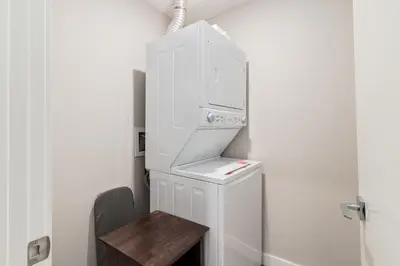 a kitchen with a white refrigerator and a wooden table at Pet Friendly, Free Parking, Close to Downtown in Calgary