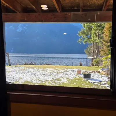 a window view of a lake from a house at Ocean's Edge in Port Alice