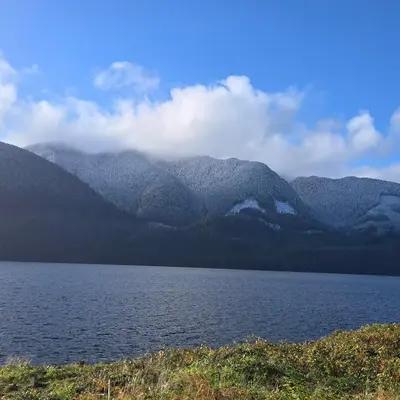 a large body of water with mountains in the background at Ocean's Edge in Port Alice