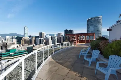 a balcony with chairs and a view of a city at The Urban Lofts in Vancouver